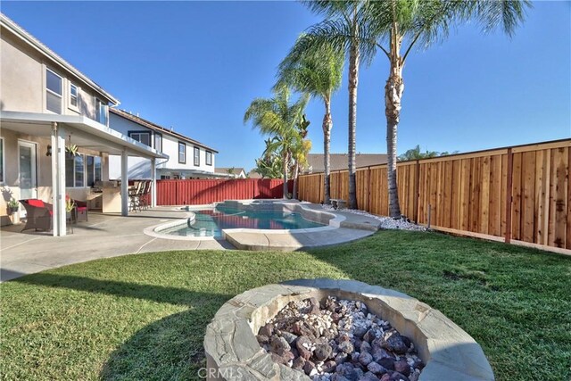 view of yard with a fenced in pool, an outdoor living space with a fire pit, and a patio