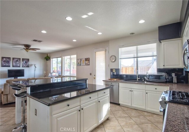 kitchen with white cabinets, stainless steel appliances, and sink