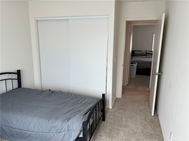 carpeted bedroom with a closet