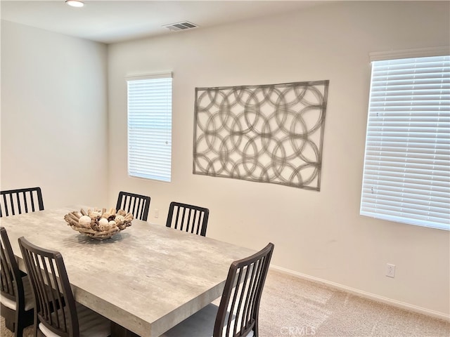 carpeted dining area with a healthy amount of sunlight