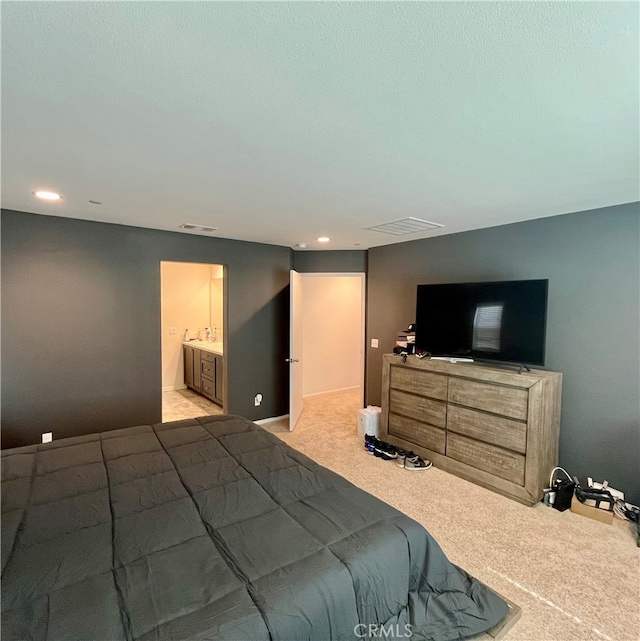 carpeted bedroom featuring ensuite bathroom