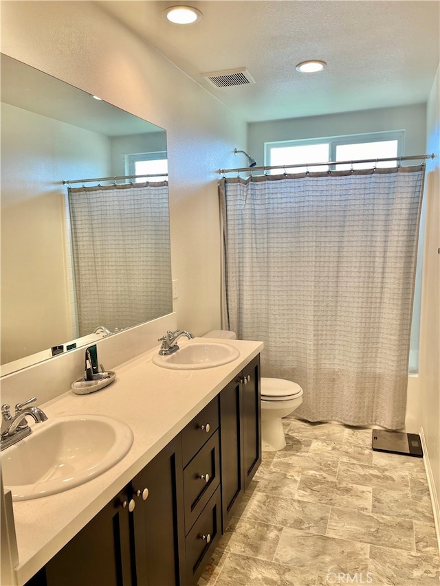 full bathroom with vanity, toilet, and shower / bath combo with shower curtain