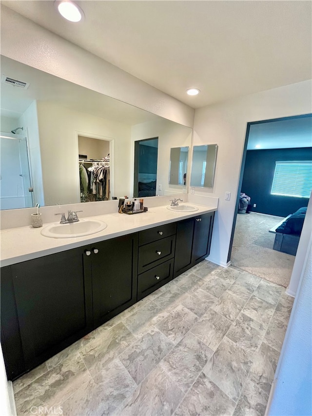 bathroom featuring vanity and an enclosed shower