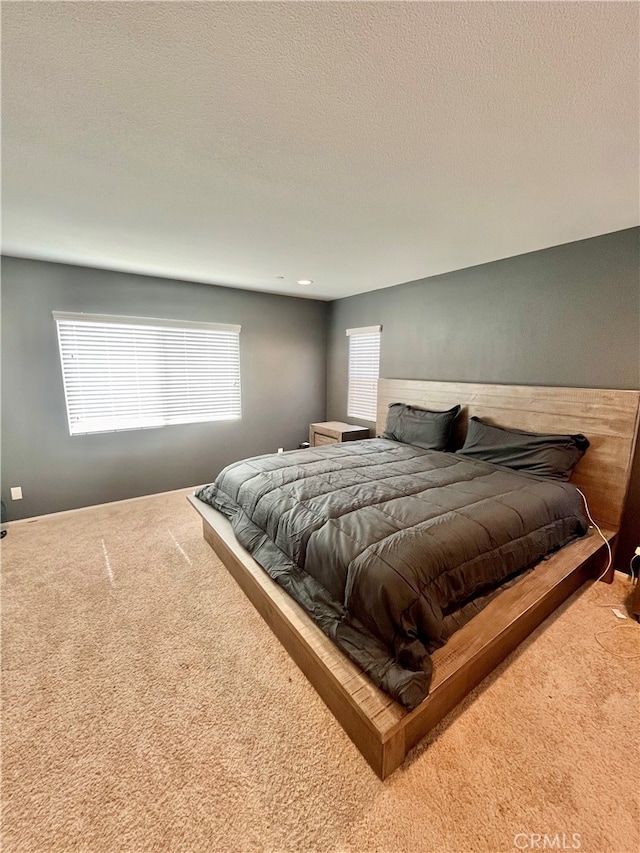 carpeted bedroom featuring a textured ceiling