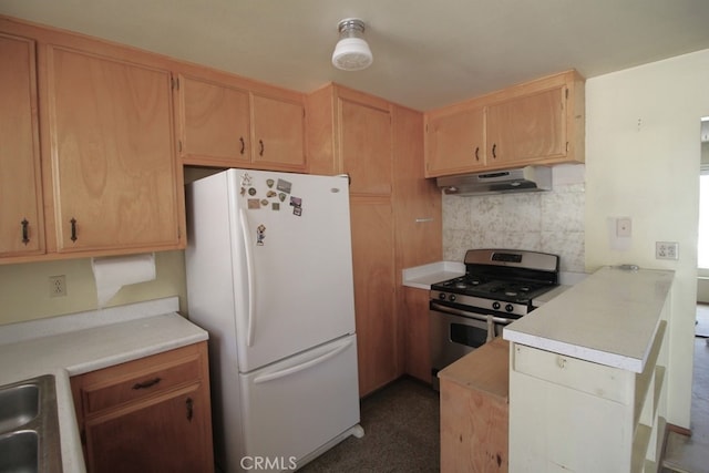 kitchen featuring stainless steel range with gas stovetop, white fridge, backsplash, light brown cabinets, and extractor fan