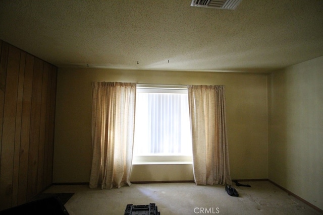 unfurnished room featuring a textured ceiling