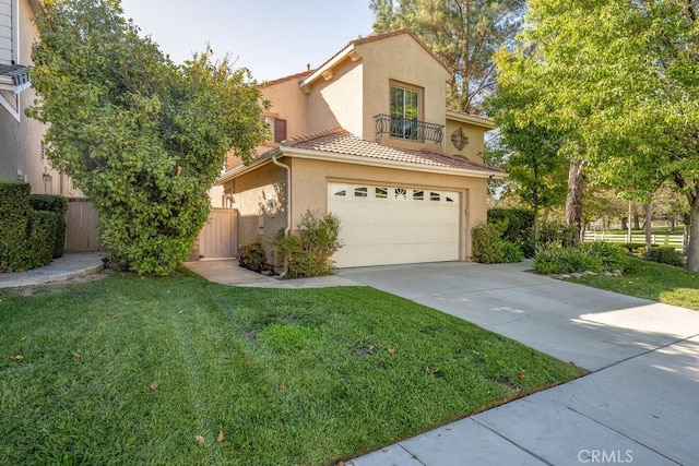 mediterranean / spanish-style home featuring a garage and a front lawn