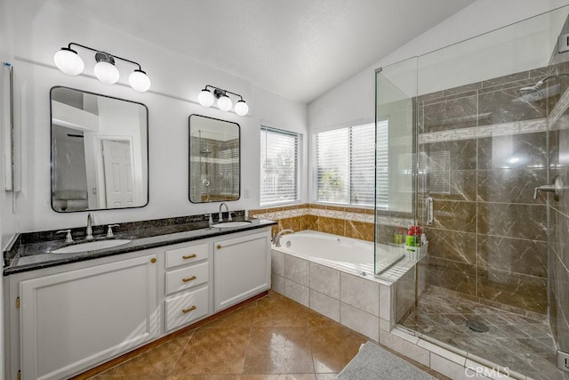 bathroom featuring tile patterned floors, vanity, independent shower and bath, and vaulted ceiling