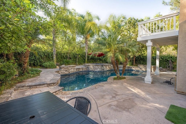 view of pool with a patio area and an in ground hot tub