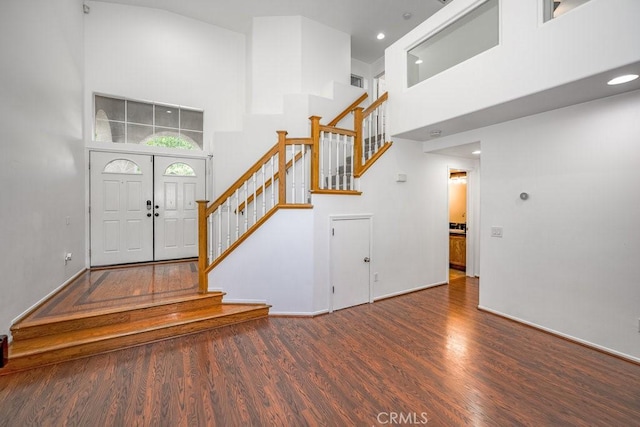 foyer with hardwood / wood-style flooring and a high ceiling