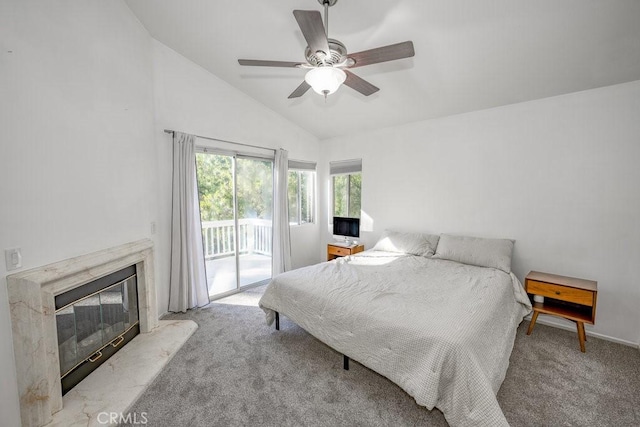 carpeted bedroom featuring access to exterior, a fireplace, ceiling fan, and lofted ceiling