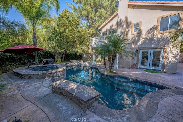 view of pool with an in ground hot tub, french doors, and a patio