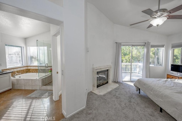 carpeted bedroom featuring multiple windows, ceiling fan, lofted ceiling, and access to exterior