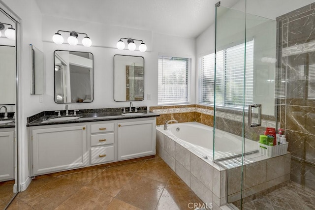 bathroom with tile patterned floors, vanity, and plus walk in shower