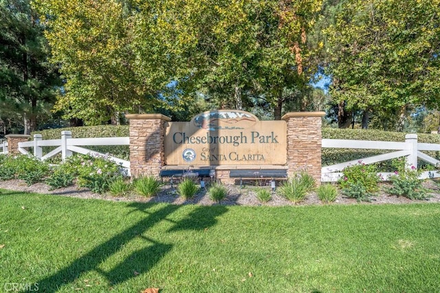 community / neighborhood sign featuring a lawn