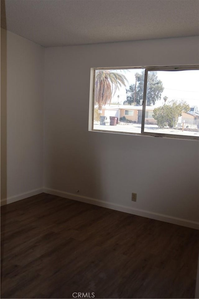 6052 Chia Ave Unit 29, Palms, CA 92277 - spare room featuring baseboards and dark wood-type flooring
