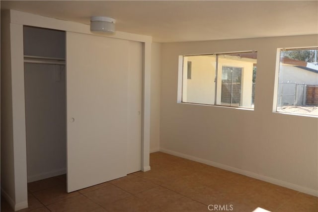 6052 Chia Ave Unit 29, Palms, CA 92277 - unfurnished bedroom with a closet, baseboards, and tile patterned flooring