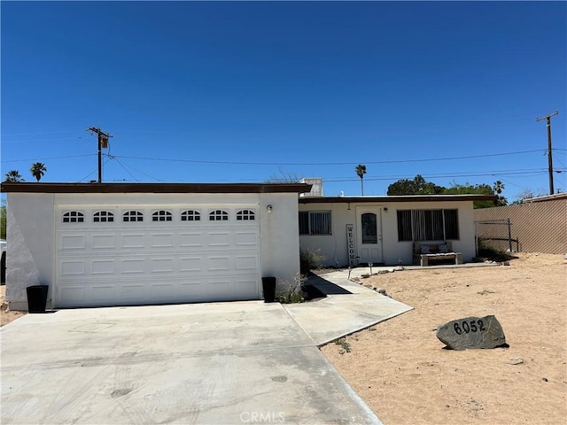 6052 Chia Ave Unit 29, Palms, CA 92277 - single story home with fence, concrete driveway, a garage, and stucco siding