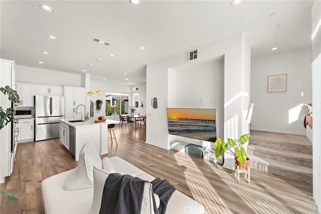 living room with sink and hardwood / wood-style flooring