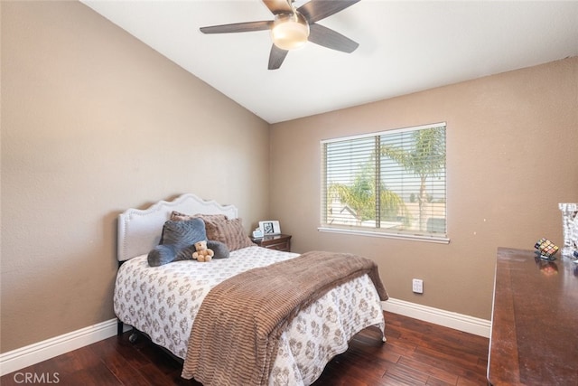 bedroom with ceiling fan, lofted ceiling, and dark hardwood / wood-style floors