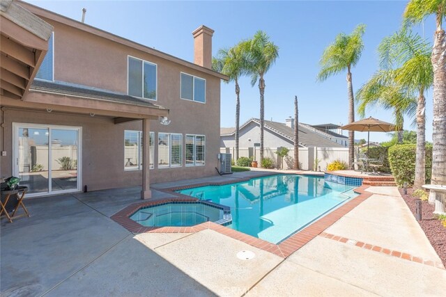 view of pool featuring an in ground hot tub and a patio