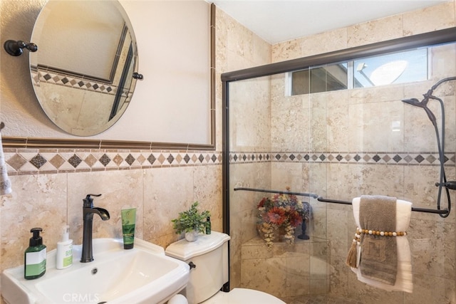 bathroom featuring tile walls, sink, toilet, and an enclosed shower