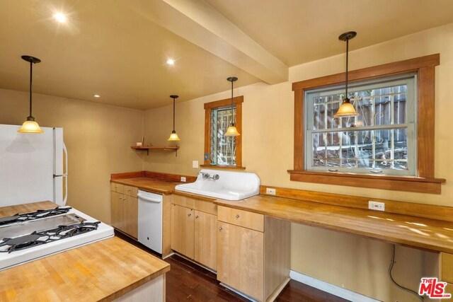 kitchen with decorative light fixtures, white appliances, butcher block countertops, and dark hardwood / wood-style floors