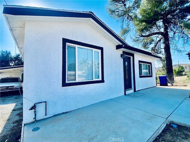 view of side of home with a patio