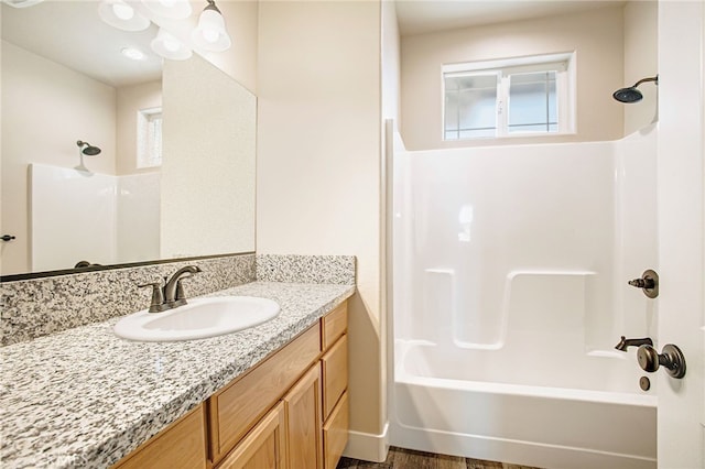 bathroom featuring shower / tub combination and vanity