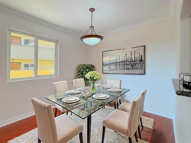 dining room featuring crown molding and wood-type flooring