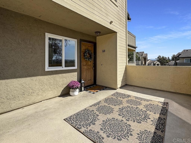 property entrance featuring a patio