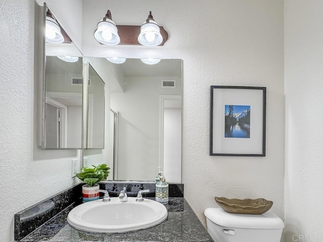 bathroom featuring toilet and sink