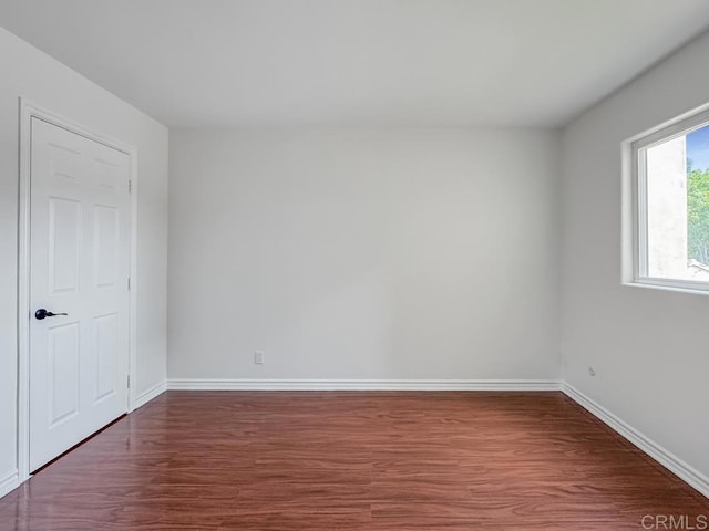 empty room with dark hardwood / wood-style floors