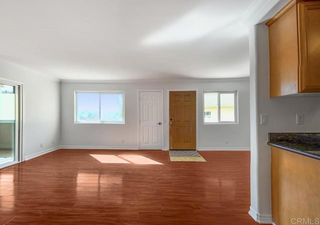 interior space featuring hardwood / wood-style flooring, plenty of natural light, and crown molding