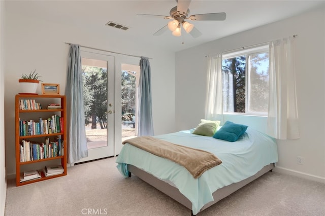 carpeted bedroom featuring multiple windows, ceiling fan, french doors, and access to exterior