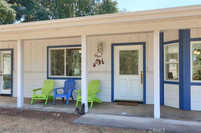 view of exterior entry with a porch