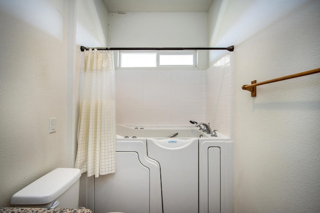 bathroom featuring independent shower and bath and toilet