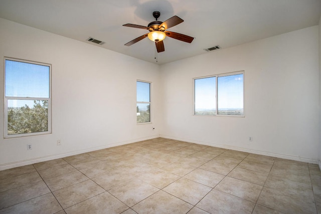 unfurnished room with ceiling fan and light tile patterned floors