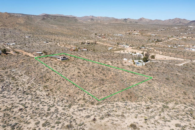 birds eye view of property with a mountain view