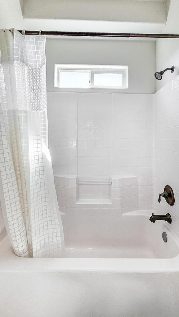 bathroom featuring shower / bath combo with shower curtain