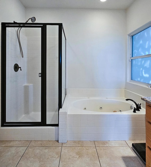 bathroom featuring shower with separate bathtub, tile patterned floors, and vanity