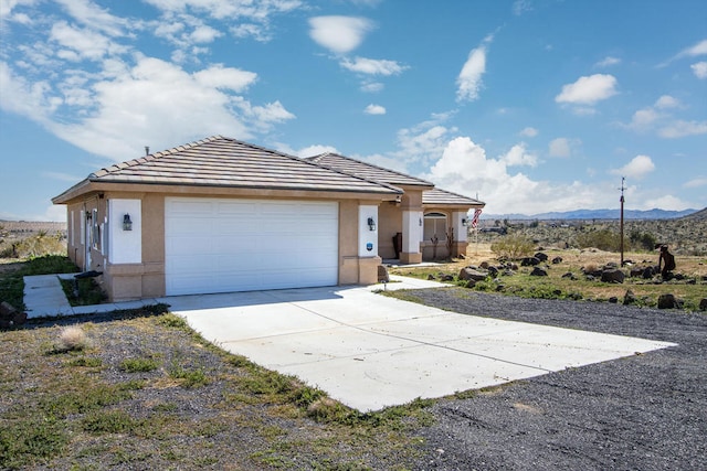 view of front of house with a mountain view and a garage