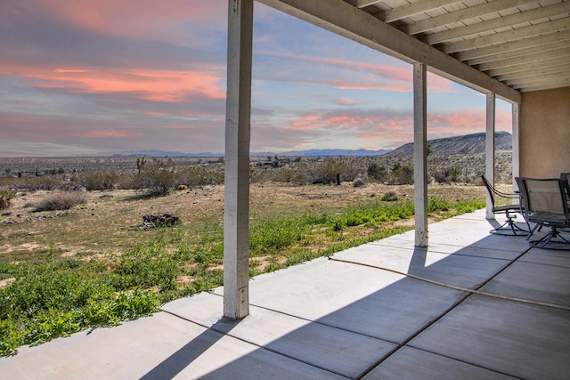 patio terrace at dusk with a mountain view