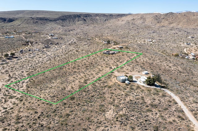 birds eye view of property featuring a mountain view