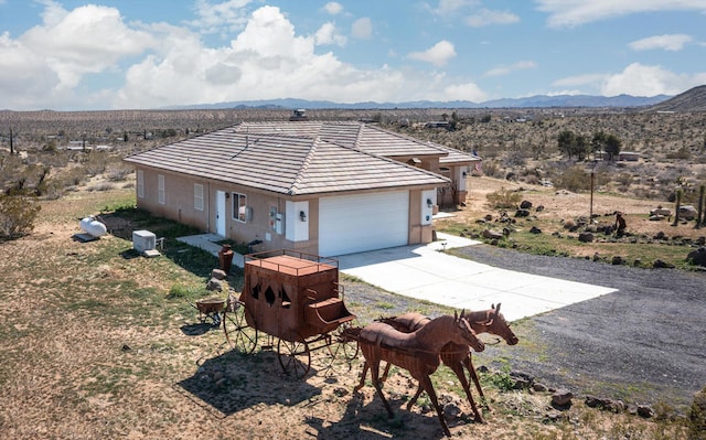 view of front of property featuring a garage and a mountain view