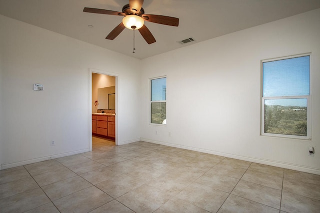 spare room featuring ceiling fan and light tile patterned flooring