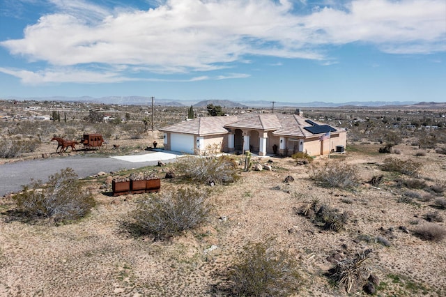 view of front facade featuring a mountain view and a garage