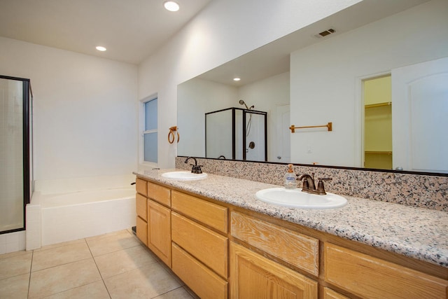 bathroom featuring vanity, shower with separate bathtub, and tile patterned flooring