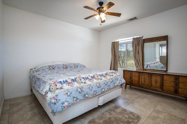 bedroom with ceiling fan and light tile patterned flooring