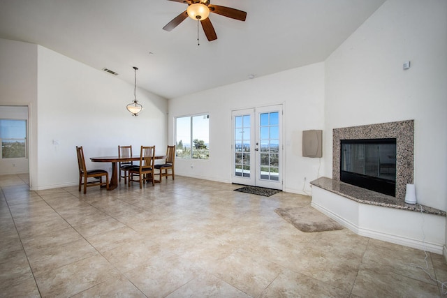 living room with ceiling fan, french doors, and high vaulted ceiling